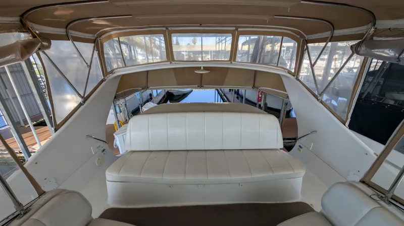 Slide: The Image of Interior of a 2002 Carver 350 Mariner yacht with white seating. - 10