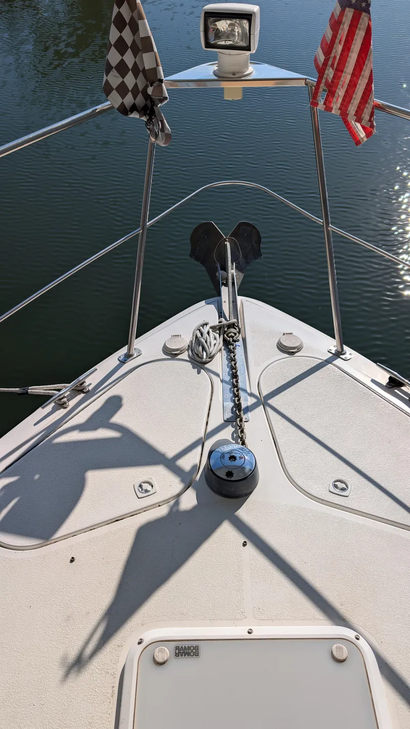 Slide: The Image of Bow of a 2002 Carver 350 Mariner with flags. - 15