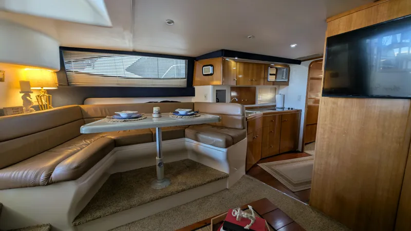 Slide: The Image of Interior of a 2002 Carver 350 Mariner yacht with dining area and kitchen. - 25