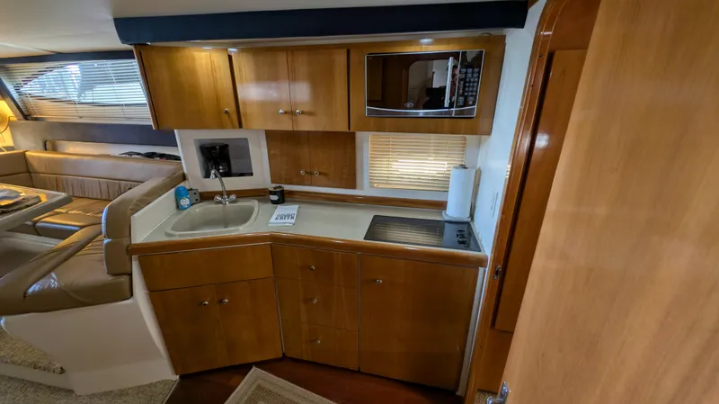 Slide: The Image of Interior of 2002 Carver 350 Mariner with kitchen and seating area. - 27