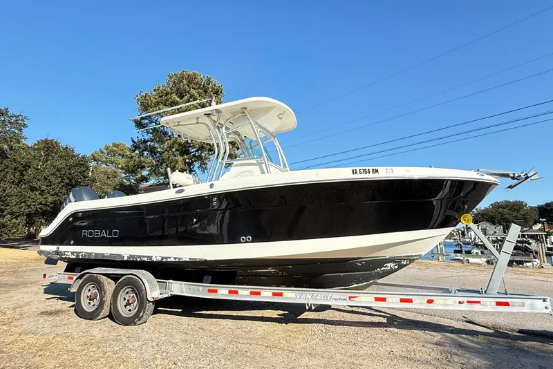 Slide: The Image of 2008 Robalo R240 Center Console boat on trailer, parked outdoors. - 0