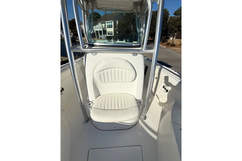 Slide: The Image of 2008 Robalo R240 Center Console boat interior with white seating and metal frame. - 12