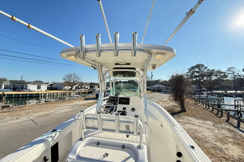 Slide: The Image of 2008 Robalo R240 Center Console boat docked near waterfront homes under clear blue sky. - 14