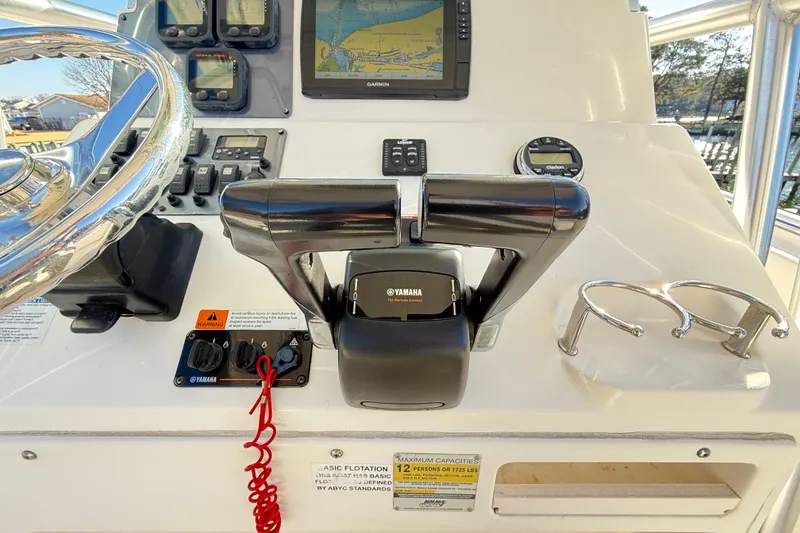 Slide: The Image of 2008 Robalo R240 Center Console helm with Yamaha controls and Garmin navigation display. - 17