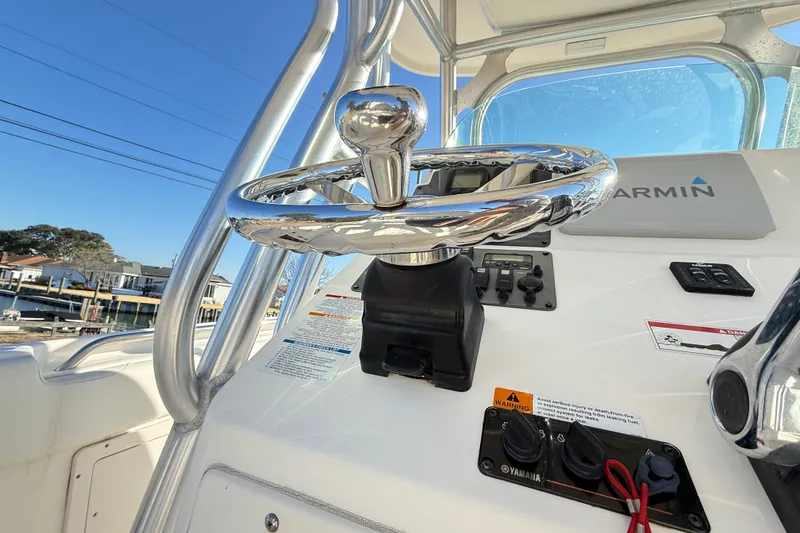 Slide: The Image of 2008 Robalo R240 Center Console steering wheel and dashboard with Garmin equipment. - 23