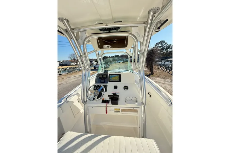 Slide: The Image of 2008 Robalo R240 Center Console boat interior with steering wheel and navigation equipment. - 24