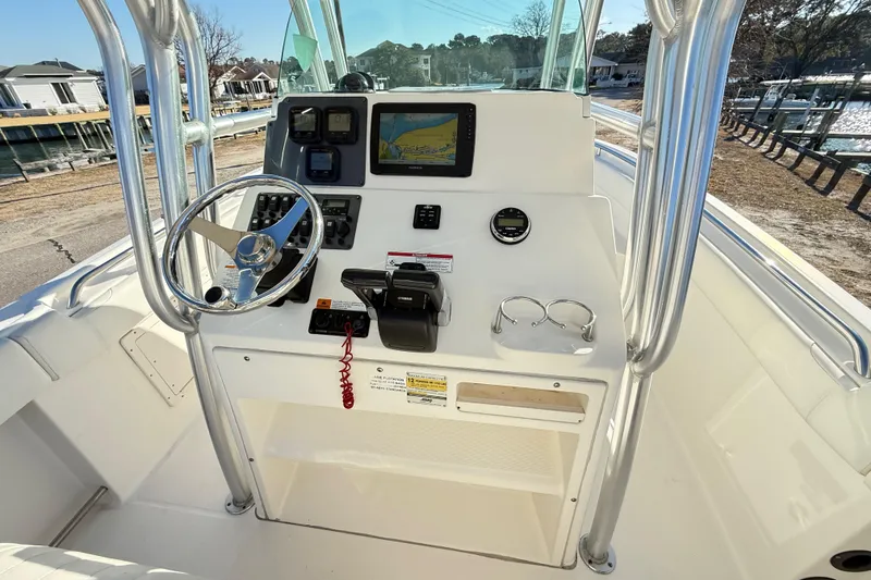 Slide: The Image of 2008 Robalo R240 Center Console boat dashboard with steering wheel and navigation equipment. - 25