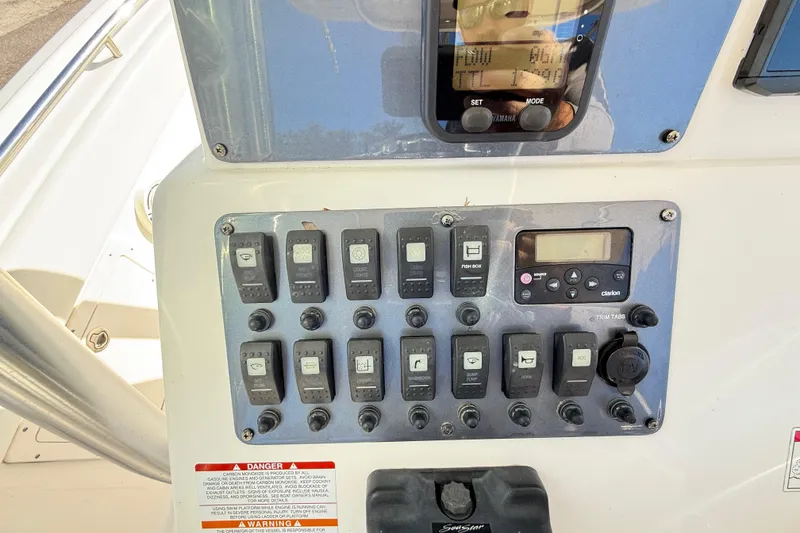 Slide: The Image of Control panel of a 2008 Robalo R240 Center Console boat with switches and display. - 26