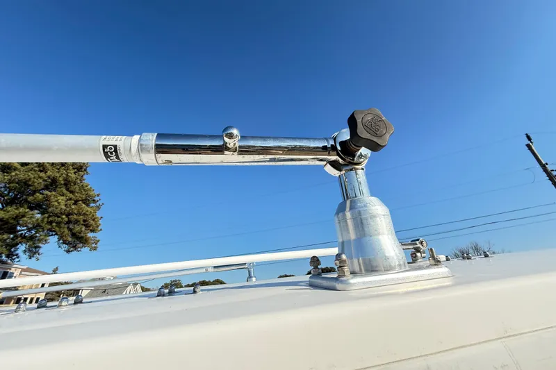Slide: The Image of Robalo R240 Center Console 2008 boat with mounted metal rod holder under clear blue sky. - 35