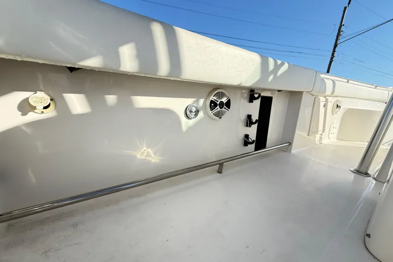 Slide: The Image of 2008 Robalo R240 Center Console boat interior with rod holders and speaker. - 36