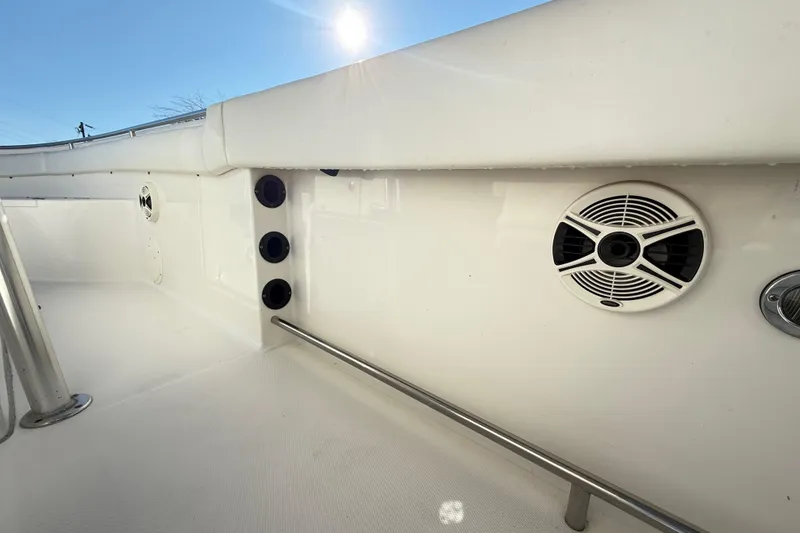 Slide: The Image of 2008 Robalo R240 Center Console boat interior with speakers and railing. - 38