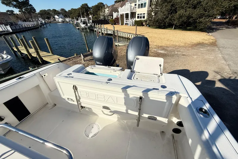 Slide: The Image of 2008 Robalo R240 Center Console boat with dual engines docked by waterfront homes. - 39