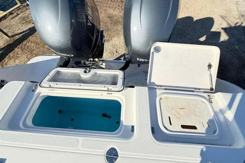 Slide: The Image of 2008 Robalo R240 Center Console boat with open storage compartments and dual Yamaha engines. - 41