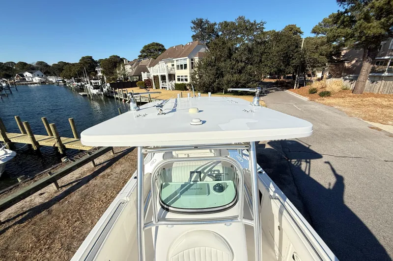 Slide: The Image of 2008 Robalo R240 Center Console boat docked near waterfront homes. - 42