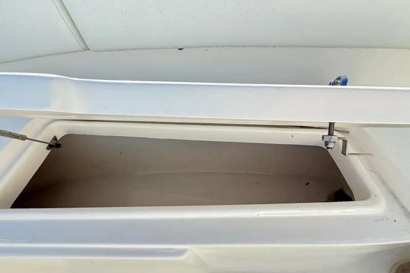 Slide: The Image of Open storage compartment on a 2008 Robalo R240 Center Console boat. - 46
