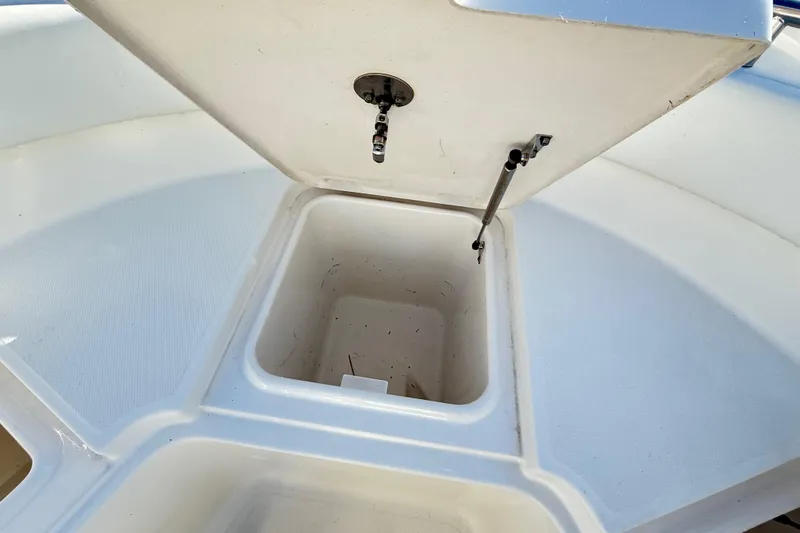 Slide: The Image of Open storage compartment on 2008 Robalo R240 Center Console boat. - 47