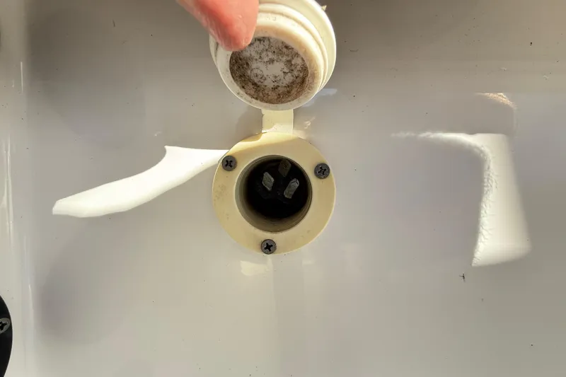 Slide: The Image of 2008 Robalo R240 Center Console boat power inlet with open cap. - 48