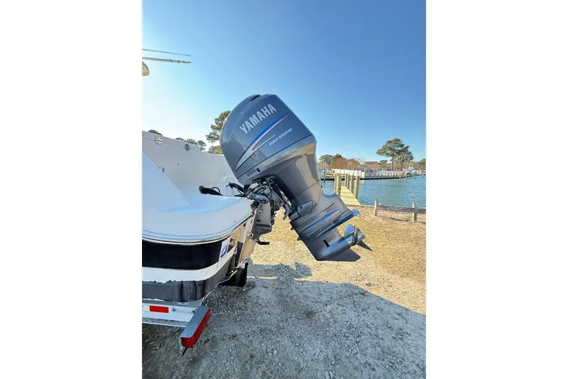Slide: The Image of 2008 Robalo R240 Center Console with Yamaha outboard motor by a lakeside dock. - 5
