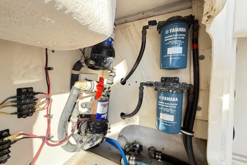Slide: The Image of 2008 Robalo R240 Center Console boat engine compartment with Yamaha fuel filters. - 50