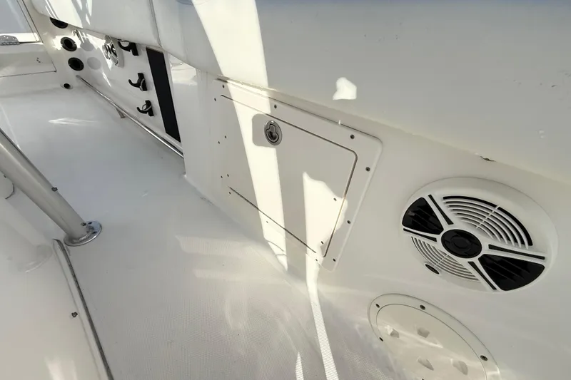 Slide: The Image of 2008 Robalo R240 Center Console interior with speaker and storage compartment. - 52