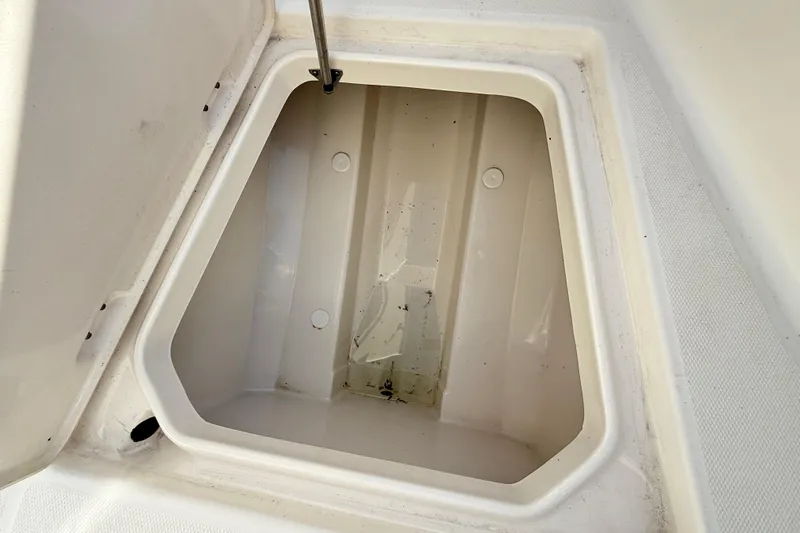 Slide: The Image of Open storage compartment on 2008 Robalo R240 Center Console boat. - 54