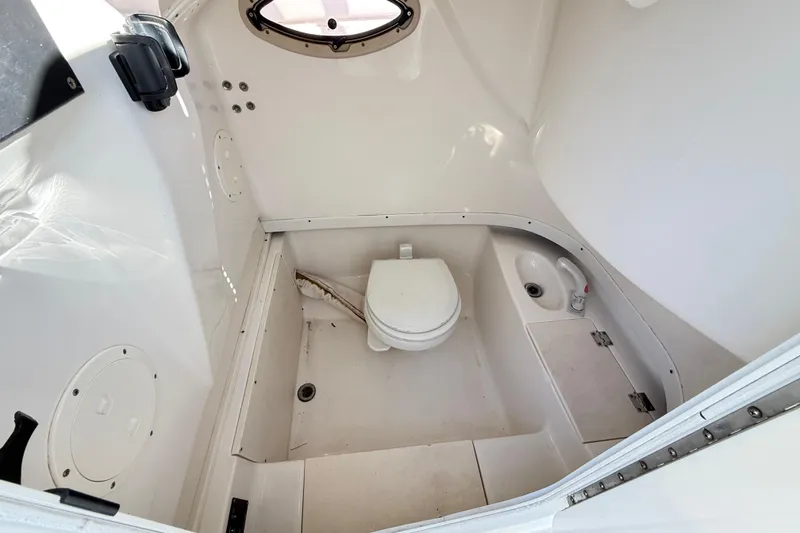 Slide: The Image of 2008 Robalo R240 Center Console boat interior with toilet and sink. - 55
