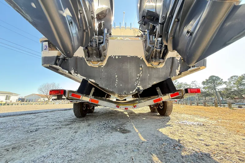 Slide: The Image of 2008 Robalo R240 Center Console boat on trailer, rear view with dual outboard motors. - 57