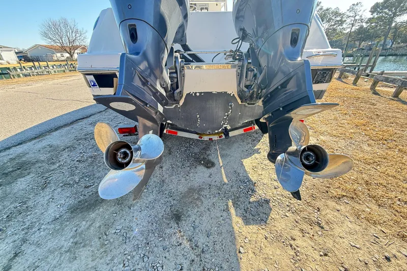 Slide: The Image of 2008 Robalo R240 Center Console boat with dual outboard motors on a trailer. - 7