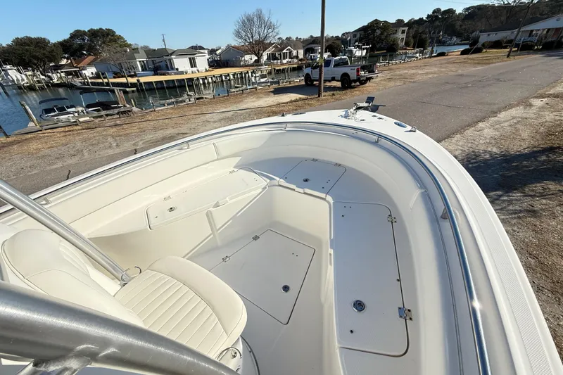 Slide: The Image of 2008 Robalo R240 Center Console boat docked near waterfront homes. - 8