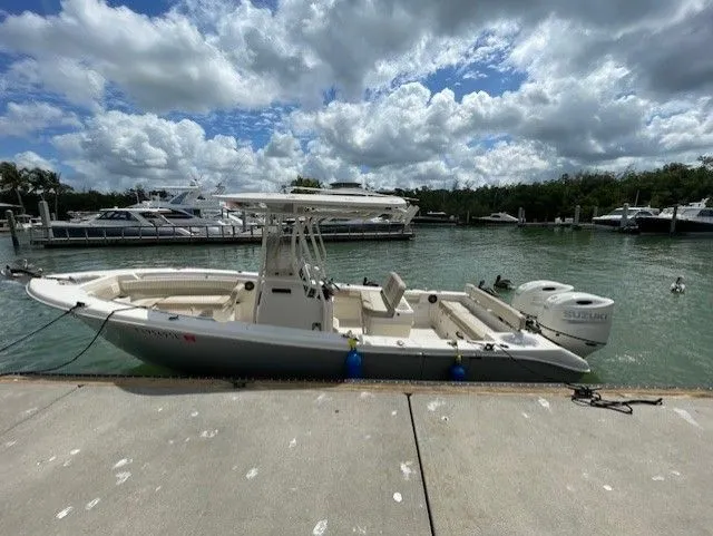 Slide: The Image of 2019 Sea Chaser 24 HFC boat docked by the water. - 2
