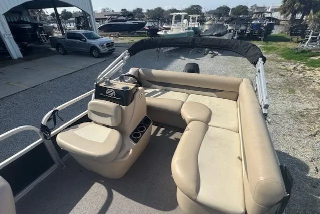 Slide: The Image of 2015 Sun Tracker Bass Buggy 16 DLX pontoon boat with beige seating and console. - 12