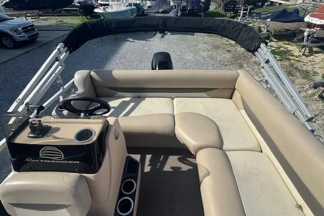 Slide: The Image of 2015 Sun Tracker Bass Buggy 16 DLX pontoon boat with beige seating and steering console. - 13
