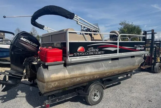 Slide: The Image of 2015 Sun Tracker Bass Buggy 16 DLX pontoon boat with Mercury engine on trailer. - 4