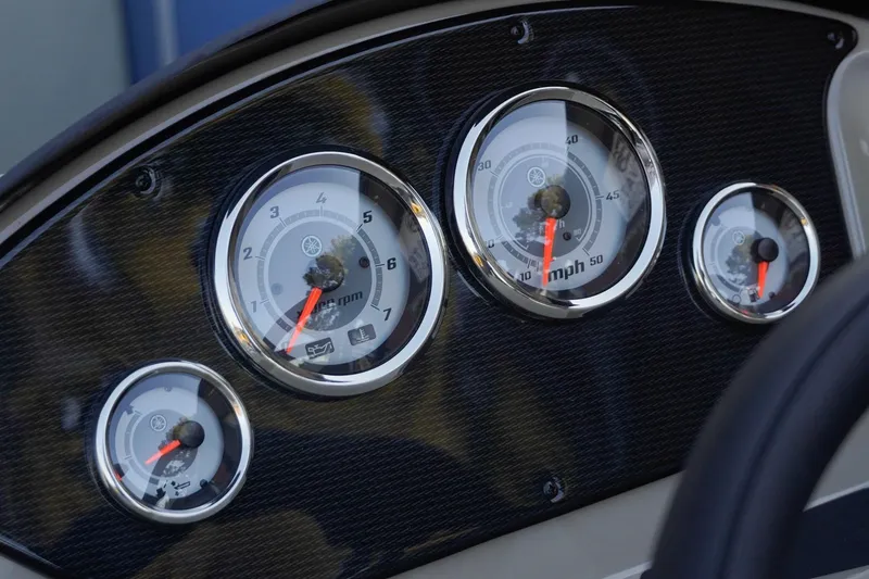 Slide: The Image of Dashboard gauges of 2026 SunCatcher Select 20F boat, featuring speedometer and tachometer. - 17