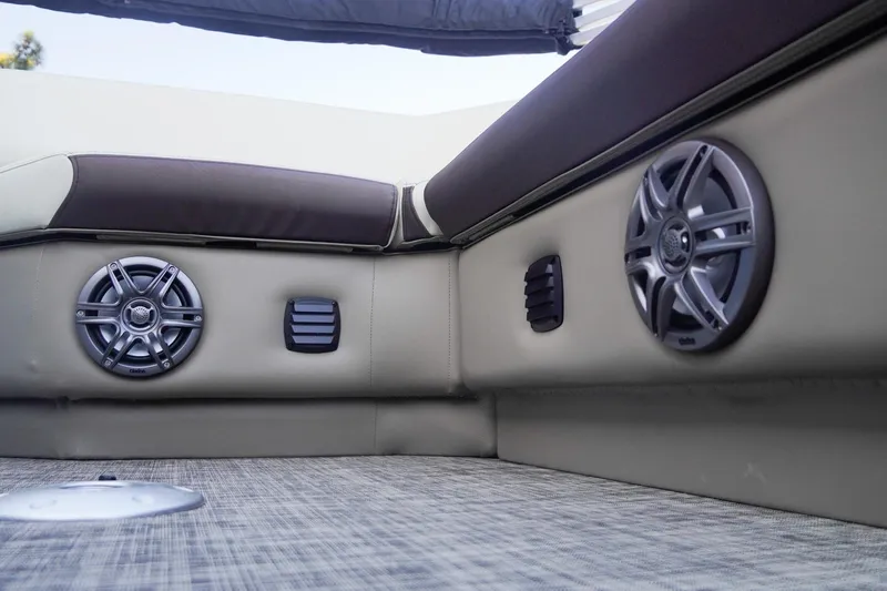 Slide: The Image of 2026 SunCatcher Select 20F boat interior with speakers and cushioned seating. - 22