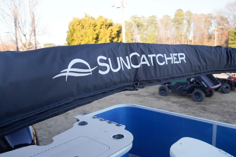 Slide: The Image of 2026 SunCatcher Select 20F boat with protective cover in outdoor setting. - 28