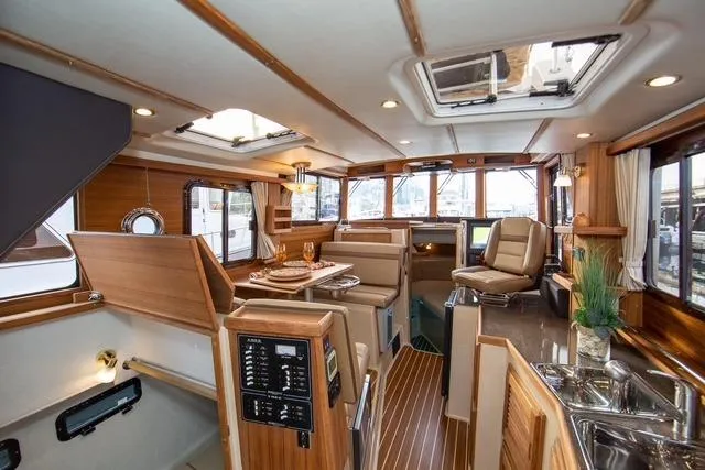 Slide: The Image of 2024 Ranger Tugs R-31 CB interior with elegant wood finish and modern amenities. - 10