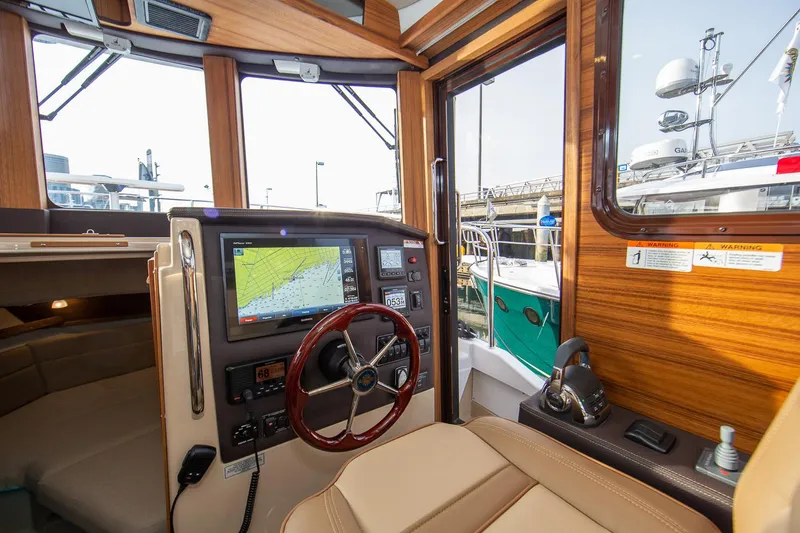 Slide: The Image of Manufacturer Provided Image: 2024 Ranger Tugs R-31 CB helm station with navigation display and controls. - 16