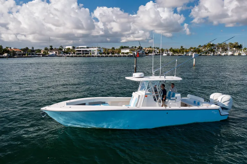 Slide: The Image of 2022 SeaVee 340Z boat on calm water with scenic coastal background. - 1