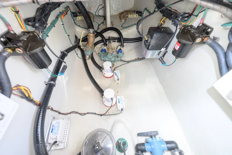 Slide: The Image of Engine compartment of 2022 SeaVee 340Z boat, showcasing wiring and mechanical components. - 13