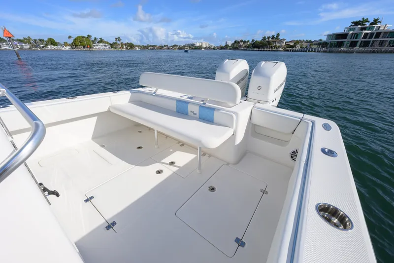 Slide: The Image of 2022 SeaVee 340Z boat with spacious deck and twin engines on calm water. - 10