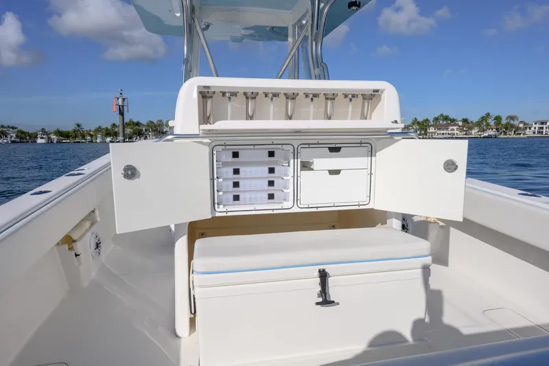 Slide: The Image of 2022 SeaVee 340Z boat interior with storage compartments open, showcasing fishing rod holders. - 12