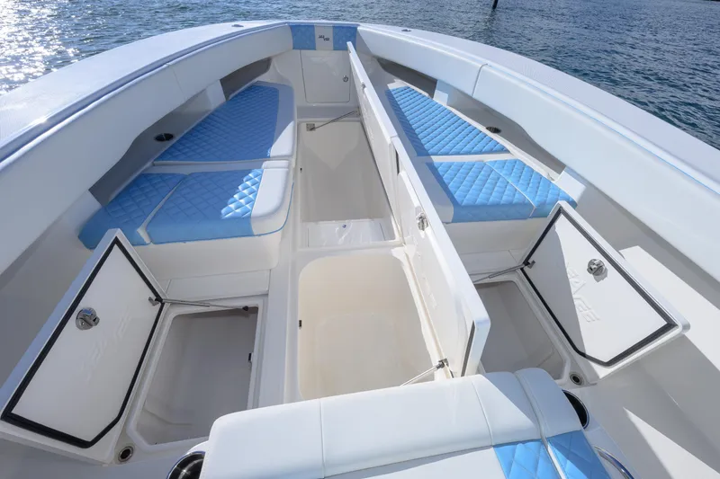 Slide: The Image of 2022 SeaVee 340Z boat interior with blue cushioned seating and open storage compartments. - 14