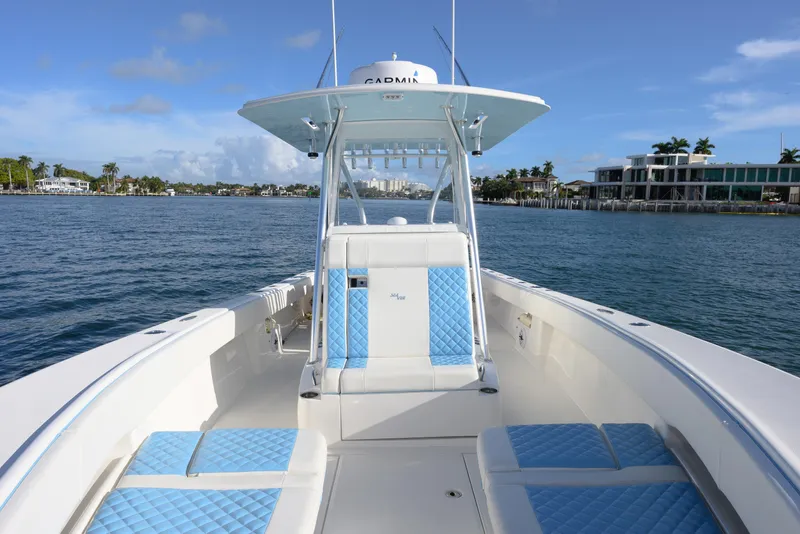 Slide: The Image of 2022 SeaVee 340Z boat with blue seating, cruising on a sunny day. - 7