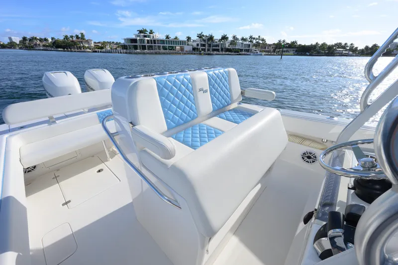 Slide: The Image of 2022 SeaVee 340Z boat interior with blue and white seating, ocean view. - 9