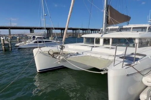 Slide: The Image of 2008 Lagoon 420 catamaran docked in marina with bridge in background. - 1