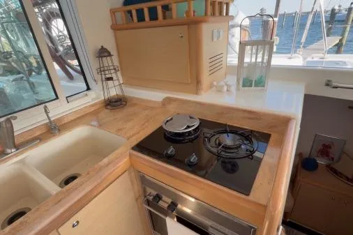 Slide: The Image of Compact kitchen in 2008 Lagoon 420 yacht with stove, sink, and window view. - 13