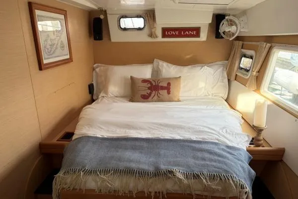 Slide: The Image of Cozy bedroom in 2008 Lagoon 420 yacht with nautical decor and comfortable bedding. - 17
