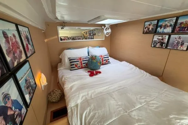 Slide: The Image of Cozy bedroom in 2008 Lagoon 420 yacht with nautical decor and family photos. - 19