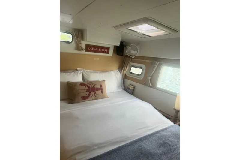 Slide: The Image of Cozy bedroom in 2008 Lagoon 420 yacht with nautical decor and natural light. - 21